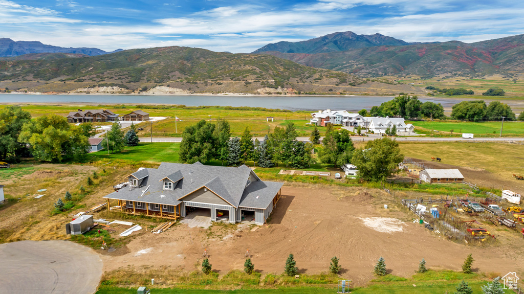 Birds eye view of property featuring a water and mountain view