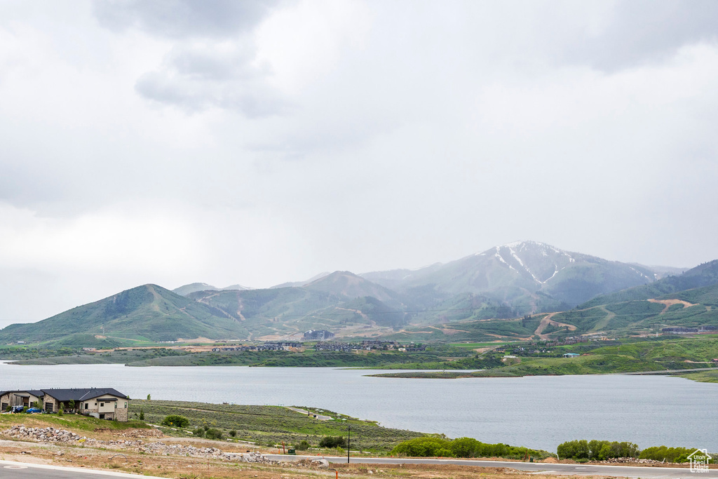 Property view of mountains featuring a water view