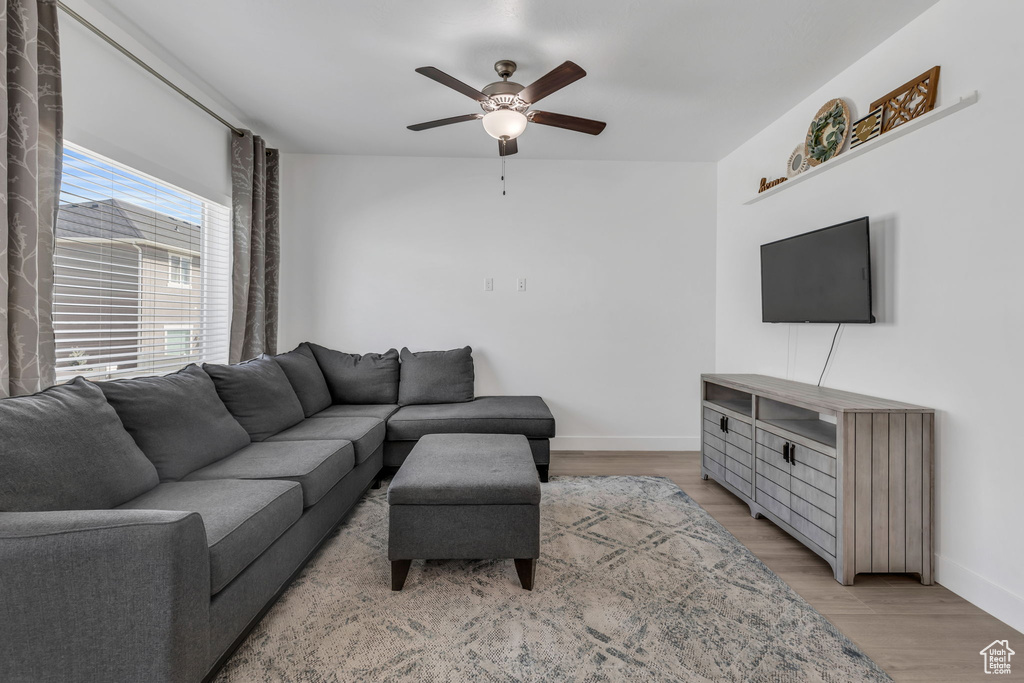 Living room featuring ceiling fan and light wood-type flooring