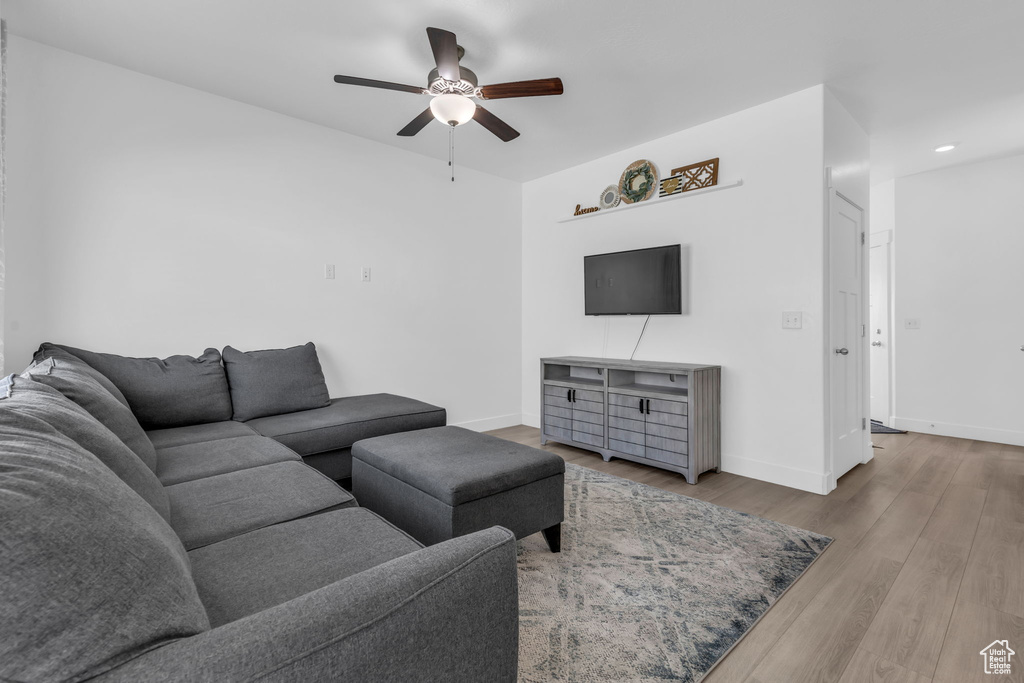 Living room featuring ceiling fan and hardwood / wood-style floors