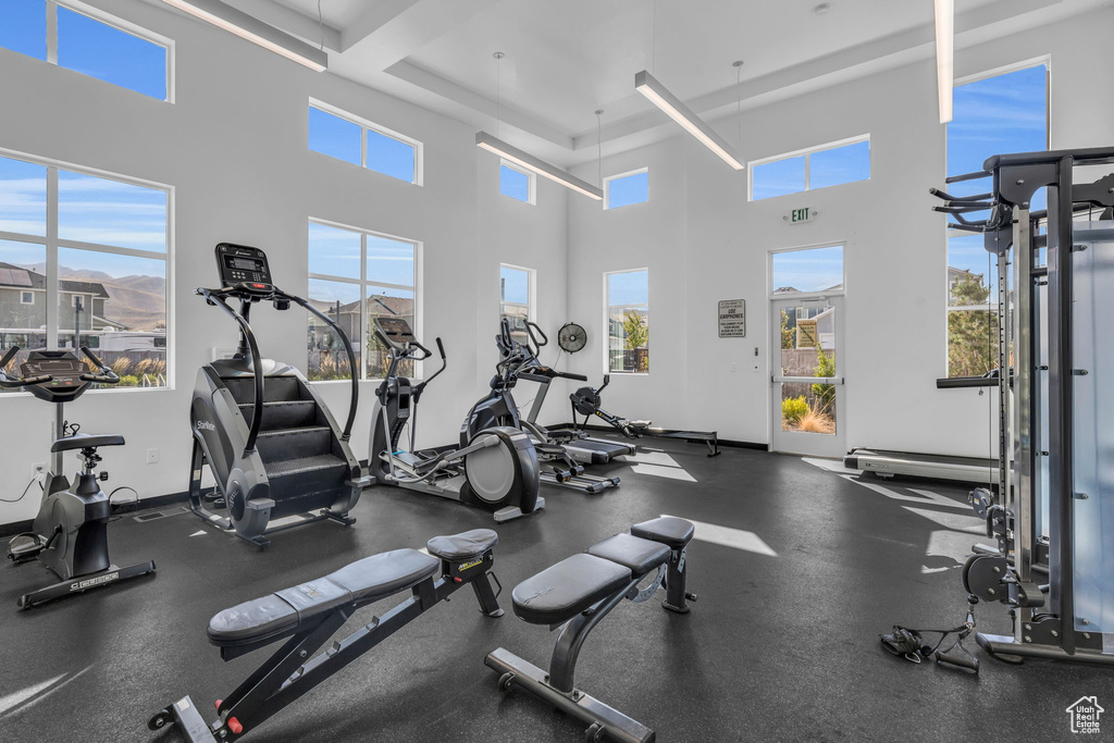 Exercise room with a towering ceiling