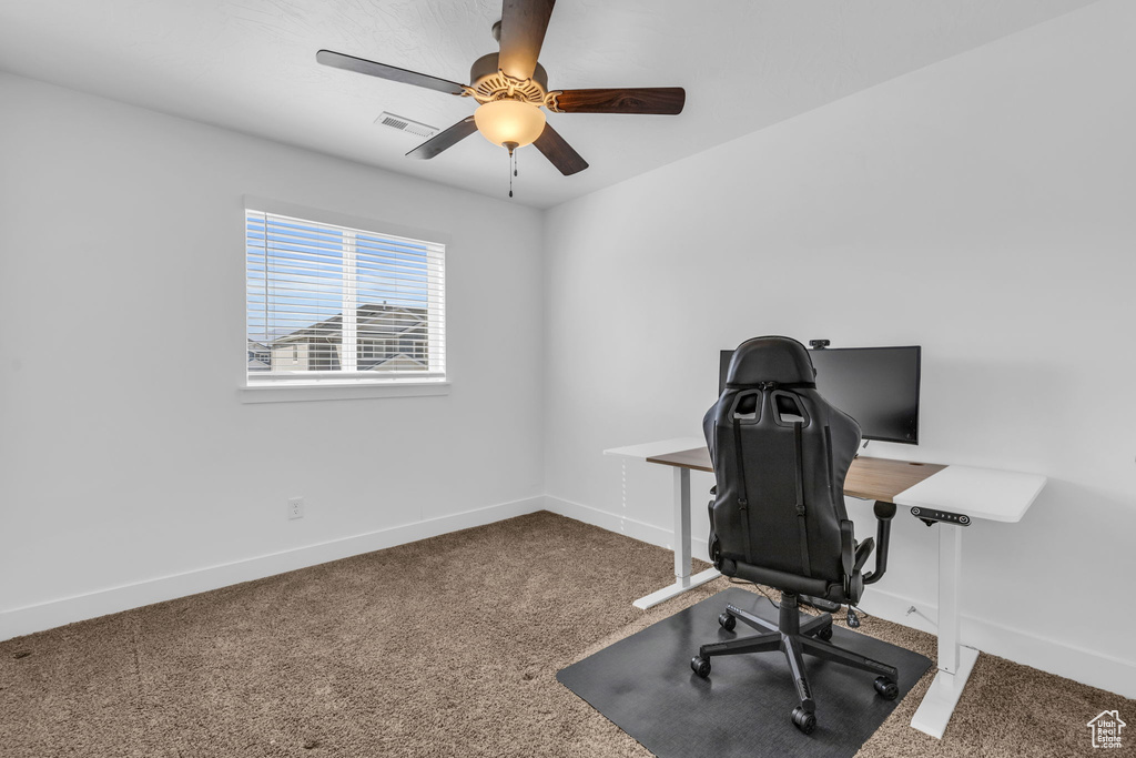 Office area featuring ceiling fan and carpet