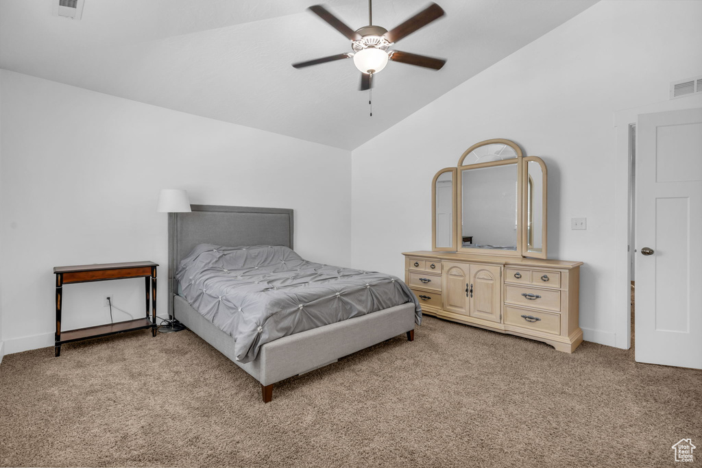 Bedroom with light carpet, lofted ceiling, and ceiling fan