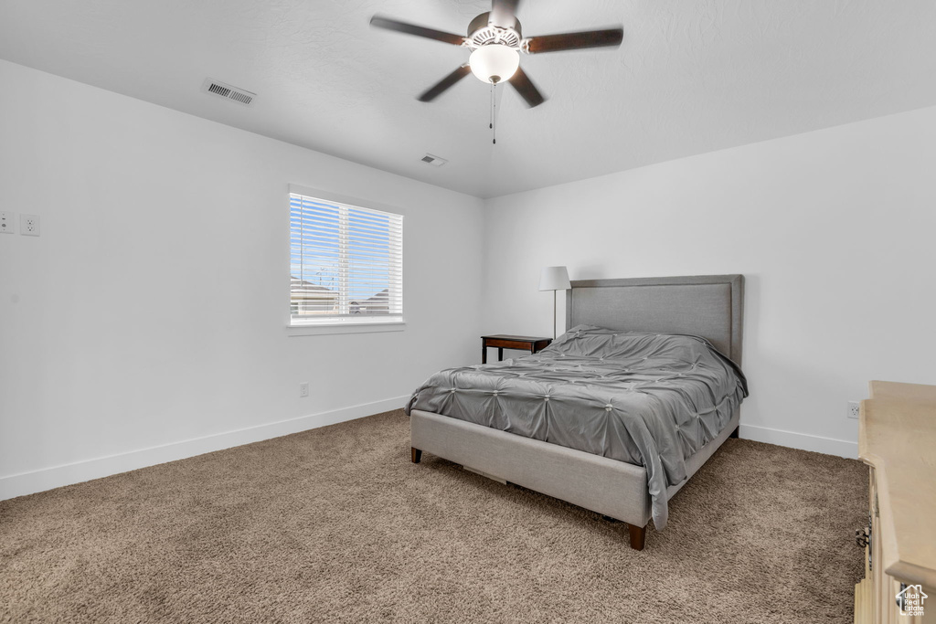 Bedroom with ceiling fan and carpet floors