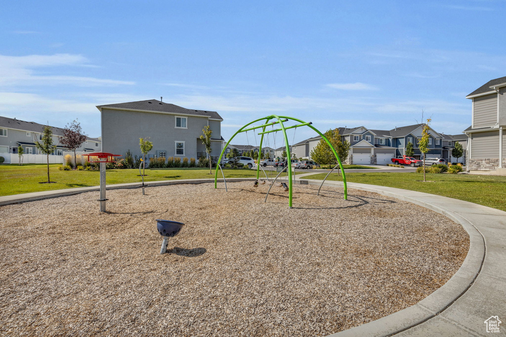 View of jungle gym featuring a lawn