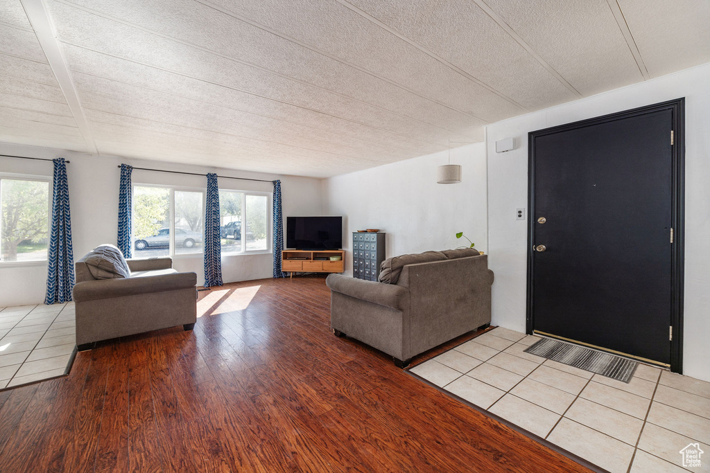 Living room featuring a textured ceiling and light hardwood / wood-style flooring