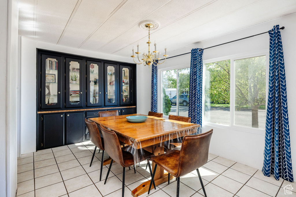 Dining area featuring a chandelier and light tile patterned flooring