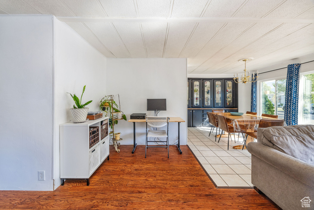 Office area featuring hardwood / wood-style flooring and an inviting chandelier