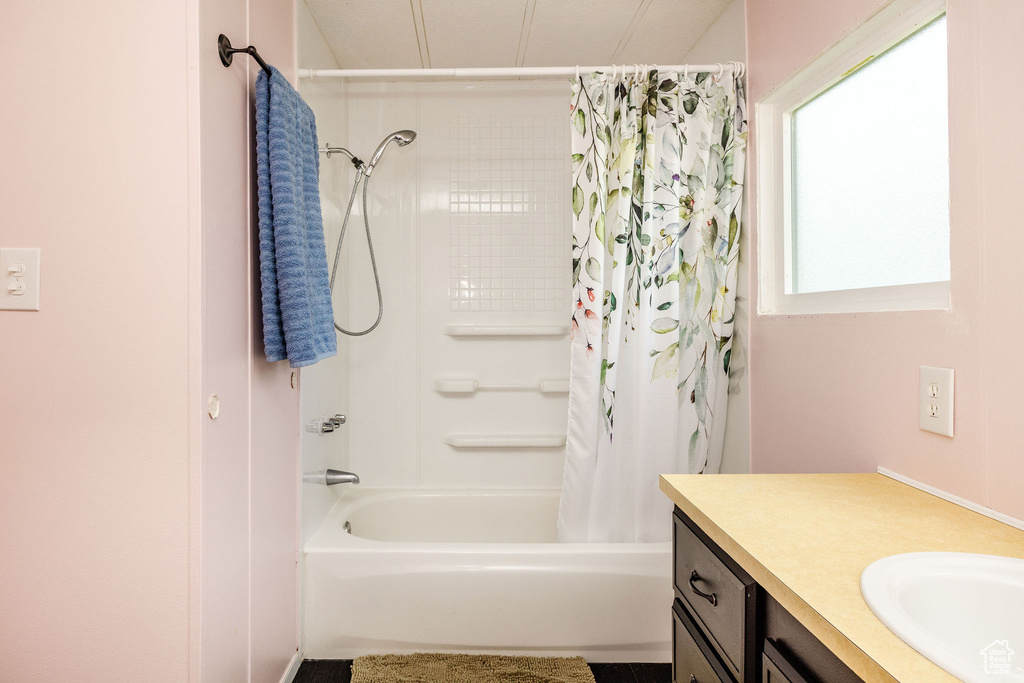 Bathroom featuring shower / tub combo and vanity