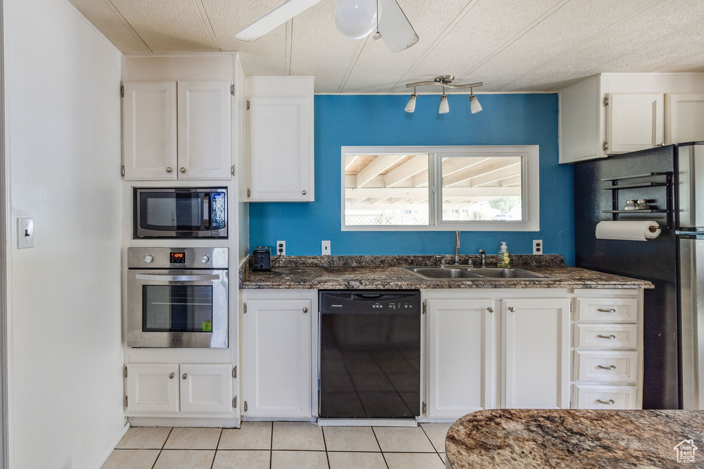 Kitchen featuring black appliances, ceiling fan, sink, and white cabinetry