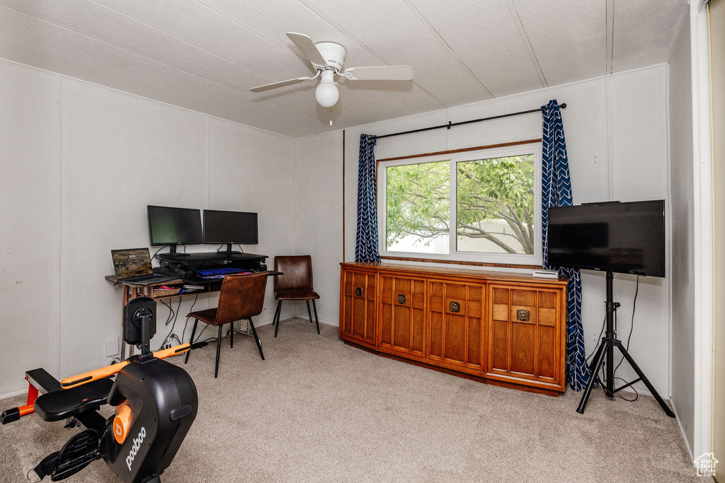 Home office with ceiling fan and light carpet