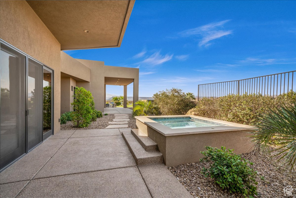 View of patio / terrace featuring an in ground hot tub