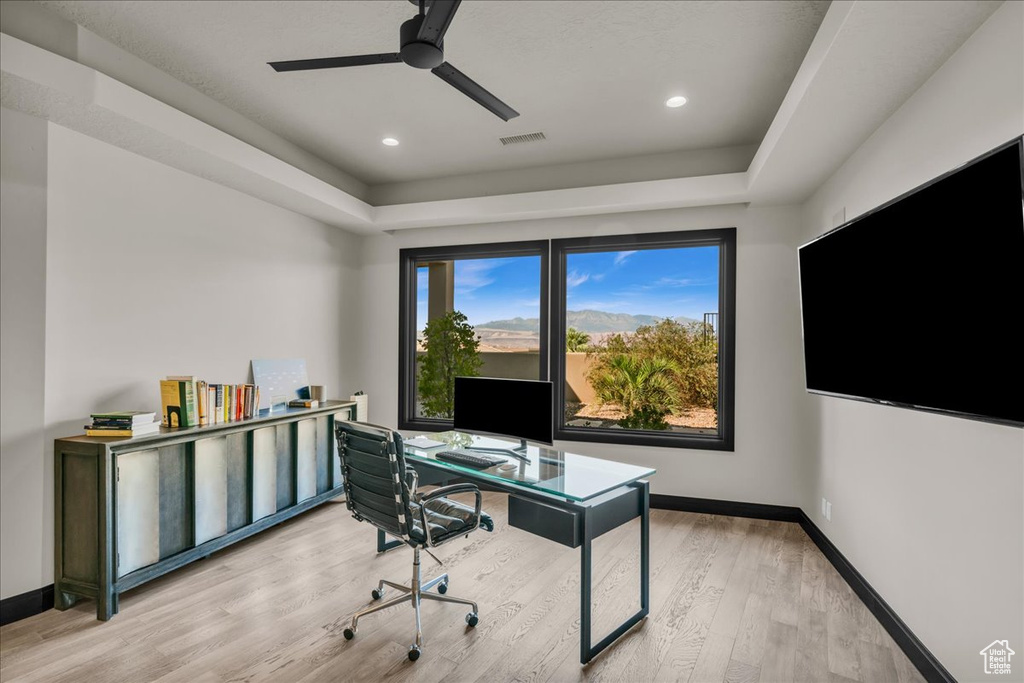 Home office featuring light wood-type flooring and ceiling fan