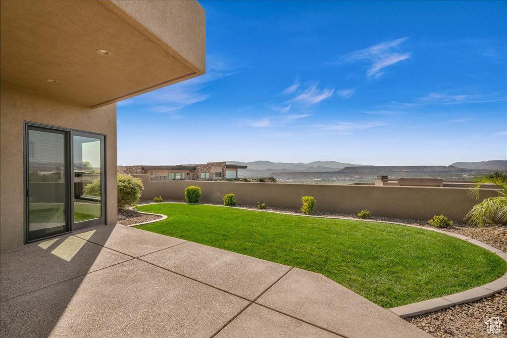 View of yard with a mountain view and a patio