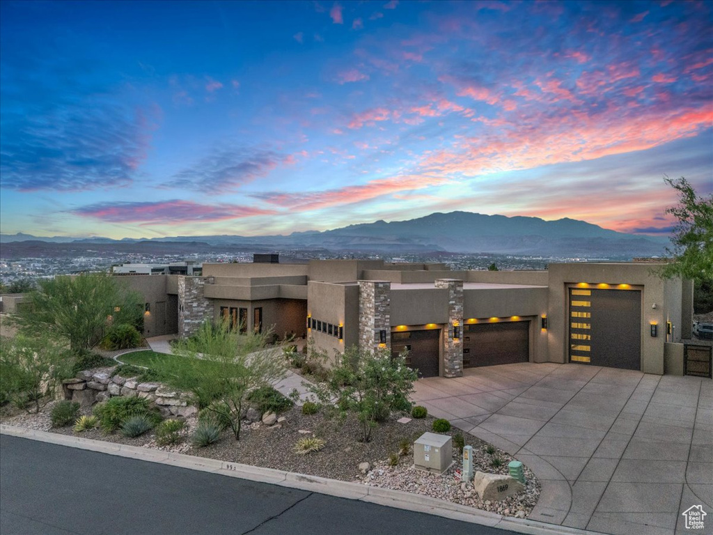 View of front of house featuring a mountain view and a garage