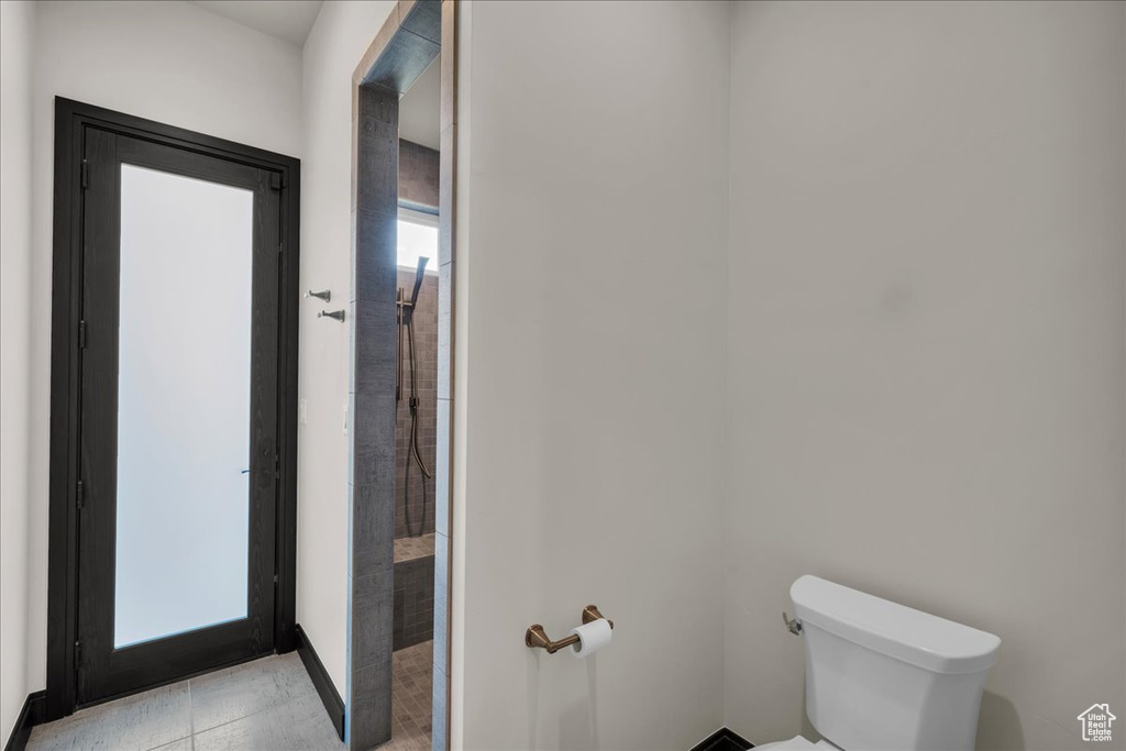 Bathroom featuring tile patterned flooring and toilet