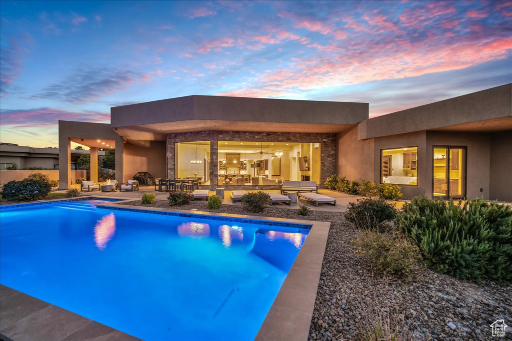 Pool at dusk with a patio area