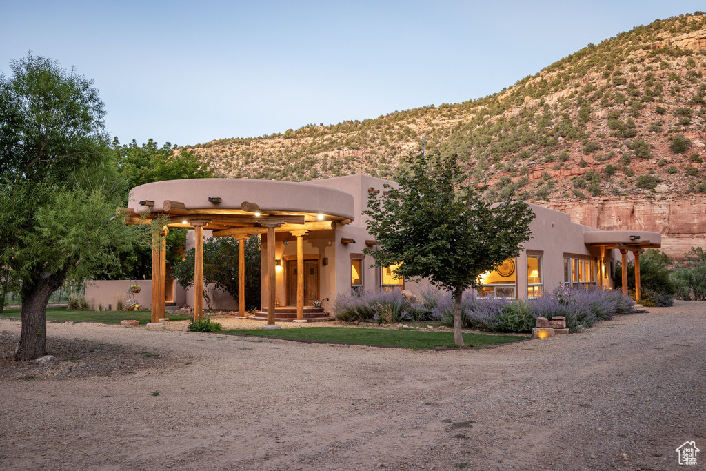 Pueblo-style house featuring a mountain view