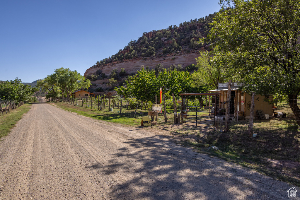View of street with a mountain view and a gate