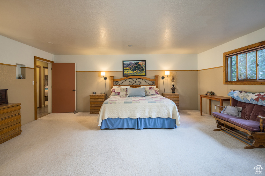 Bedroom with carpet floors and a textured ceiling