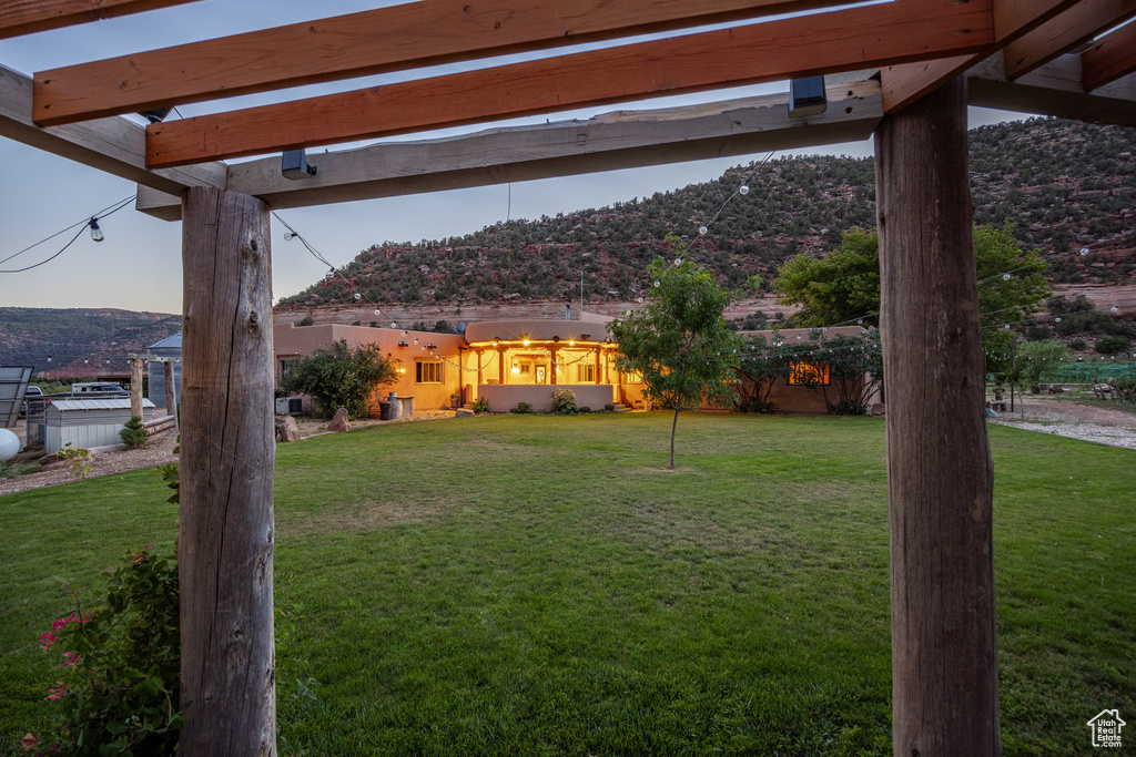 Yard at dusk featuring a mountain view