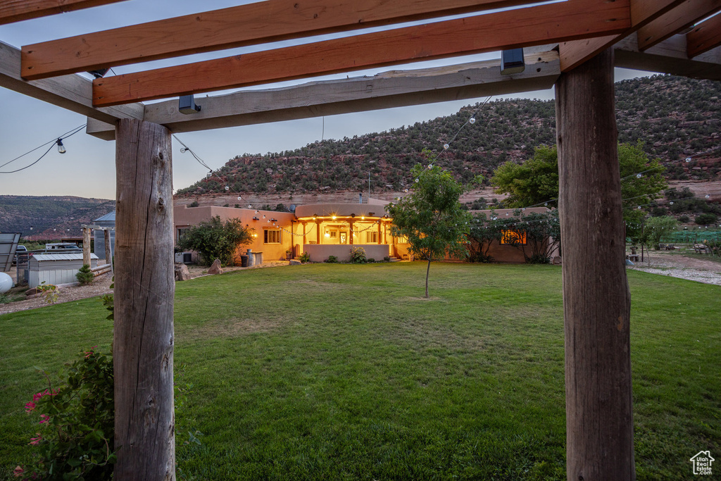 View of yard with a pergola and a mountain view