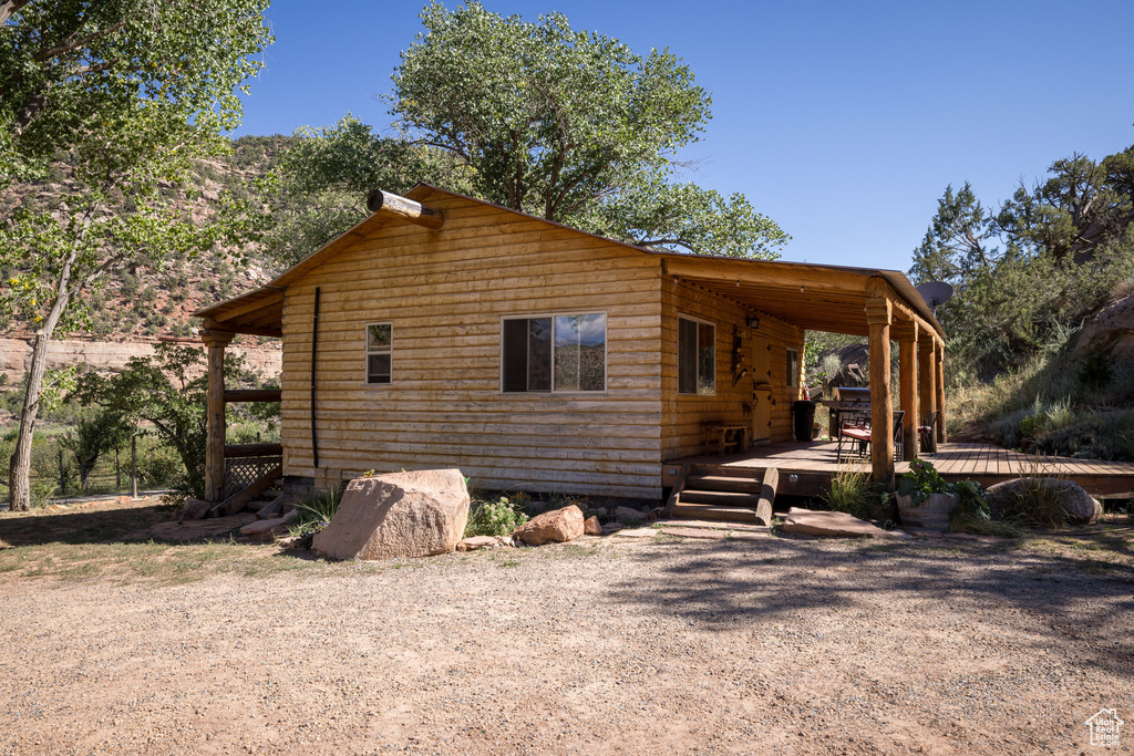 View of home's exterior with a wooden deck