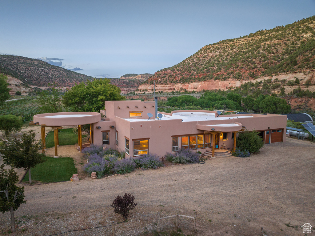 View of front of house with stucco siding and a mountain view