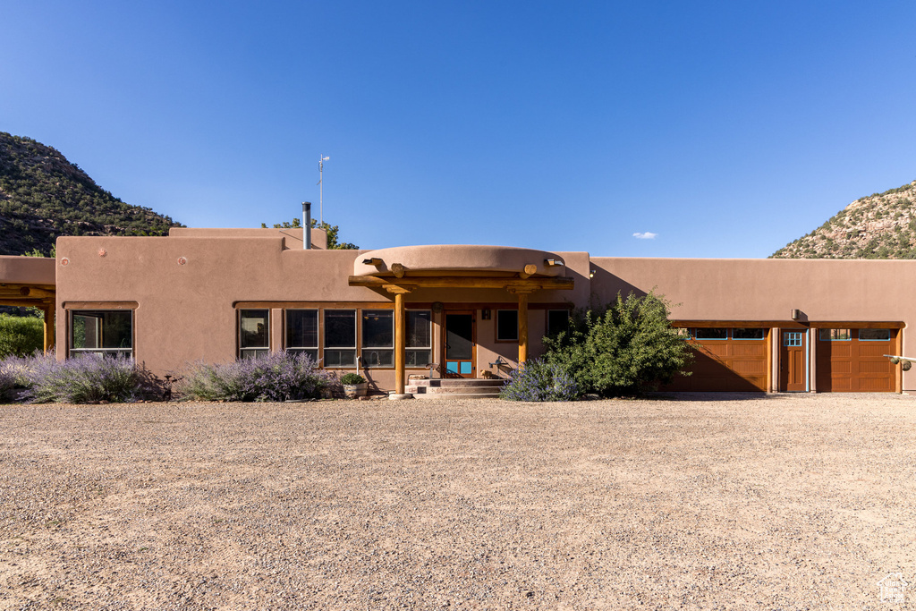 Back of house featuring a mountain view and a garage