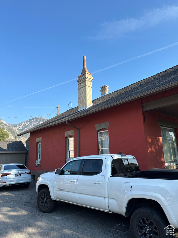 View of side of home featuring a mountain view