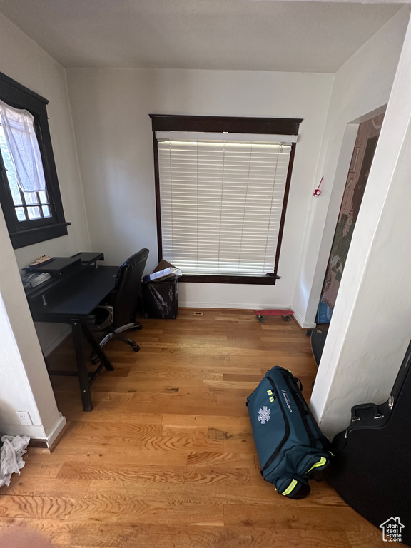 Home office with light wood-type flooring