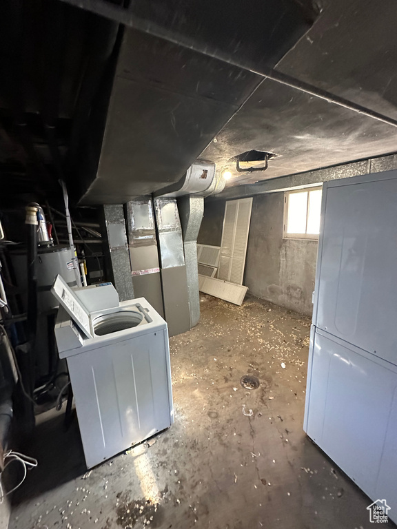 Basement featuring heating unit and washer / dryer