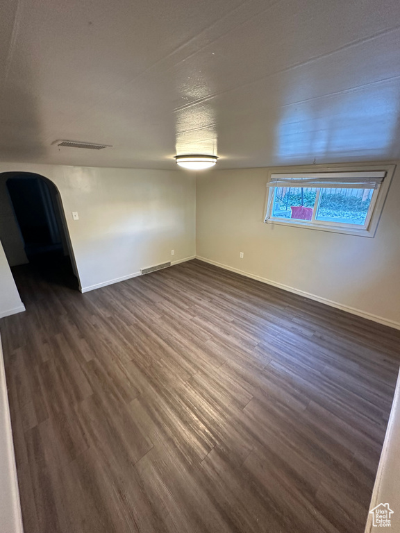 Unfurnished room featuring dark hardwood / wood-style flooring