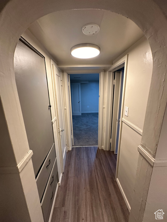 Hallway with dark hardwood / wood-style floors