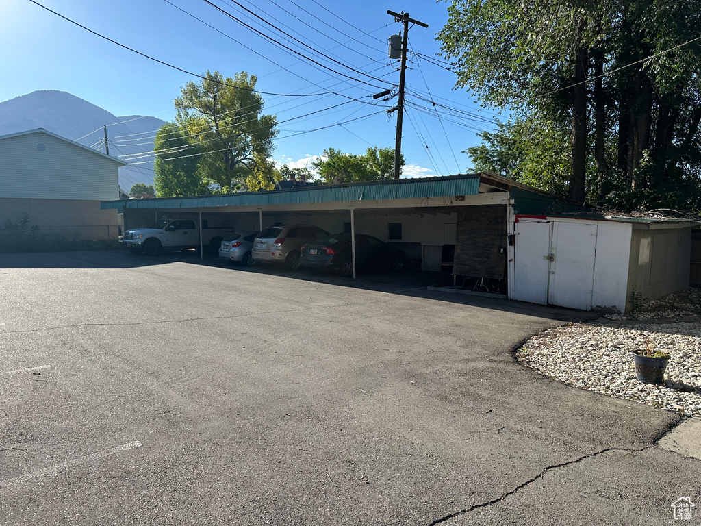 View of car parking with a mountain view and a carport