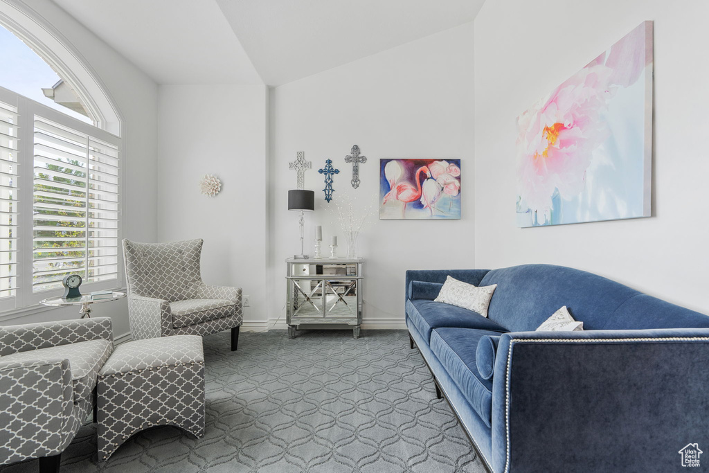 Living room with dark carpet and vaulted ceiling