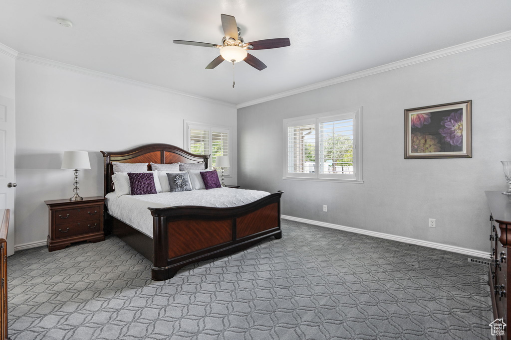 Bedroom with ceiling fan, carpet floors, and ornamental molding