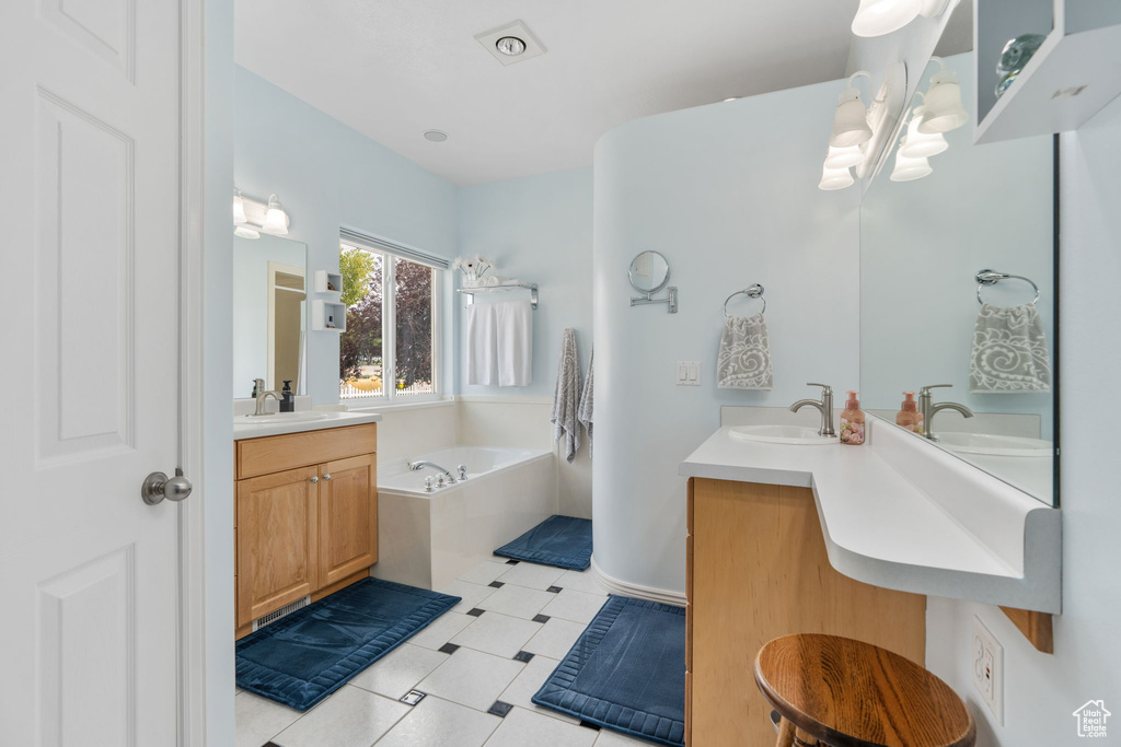 Bathroom with vanity and a relaxing tiled tub