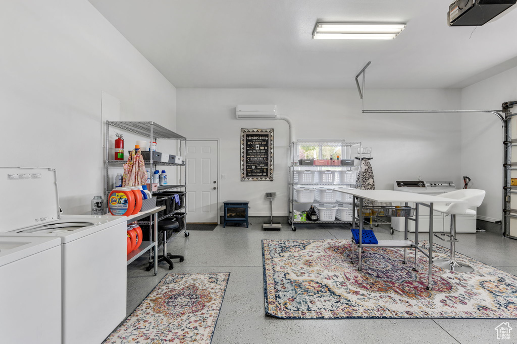 Interior space featuring a wall mounted AC, independent washer and dryer, and a garage door opener