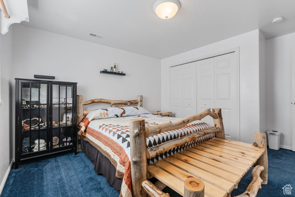 Carpeted bedroom featuring a closet