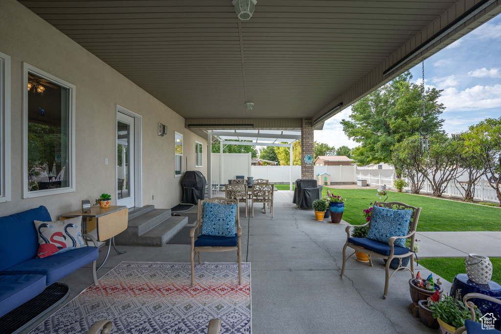 View of patio featuring an outdoor hangout area and a storage unit