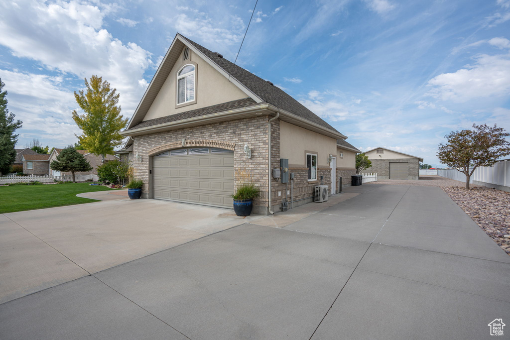 View of side of property featuring a garage