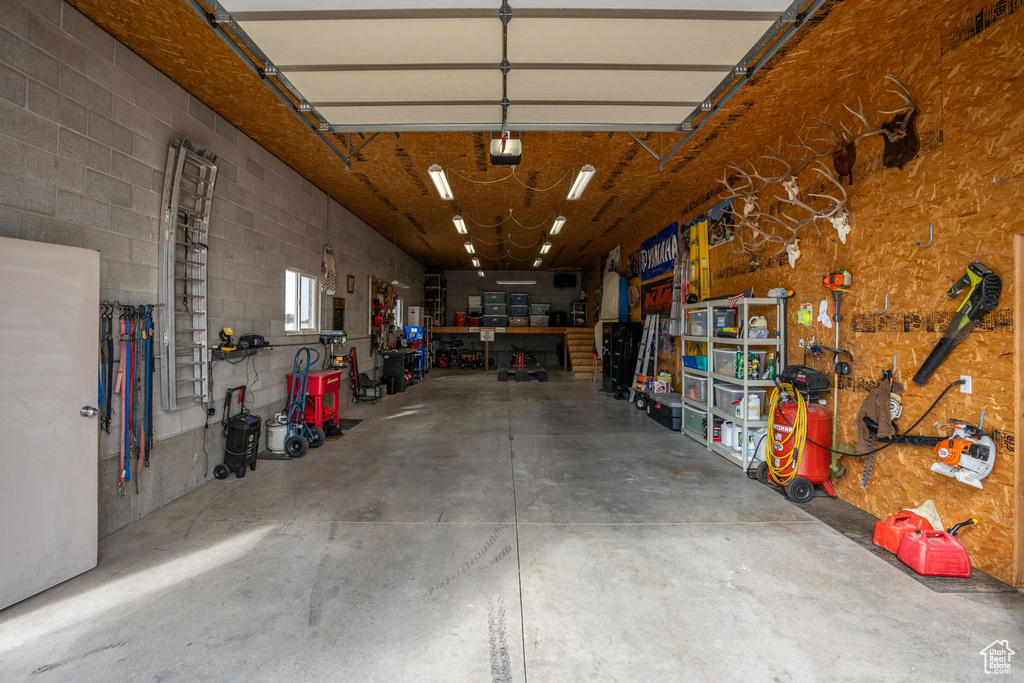 Garage with a garage door opener and a workshop area