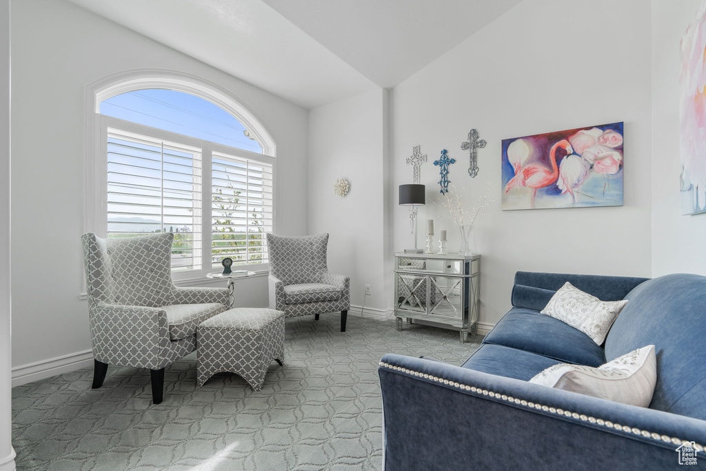 Carpeted living room with vaulted ceiling