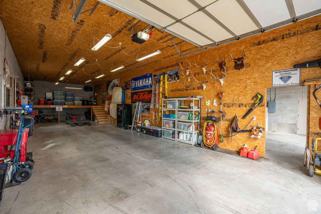 Garage with a workshop area and a garage door opener