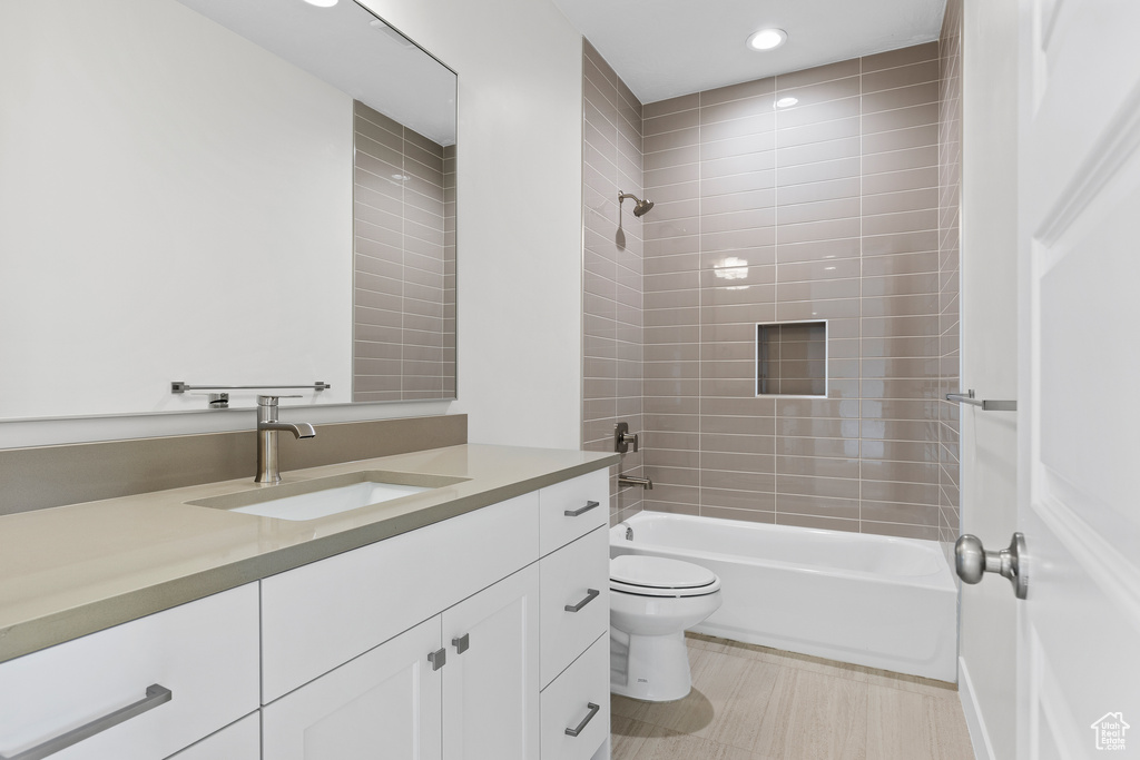 Full bathroom with toilet, shower / tub combination, tile patterned flooring, vanity, and recessed lighting