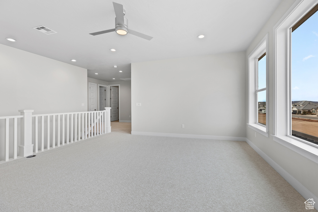 Unfurnished room with baseboards, light colored carpet, visible vents, and recessed lighting