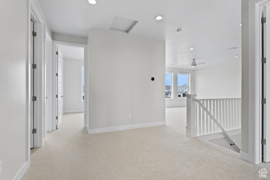 Hallway featuring recessed lighting, attic access, an upstairs landing, and light colored carpet