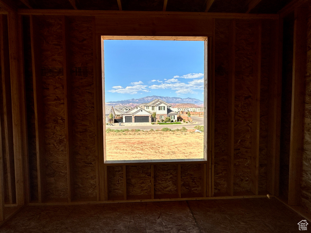 Empty room featuring a mountain view and a healthy amount of sunlight