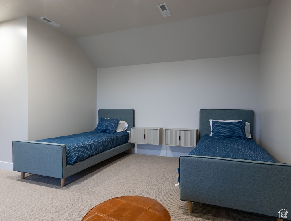 Carpeted bedroom with vaulted ceiling